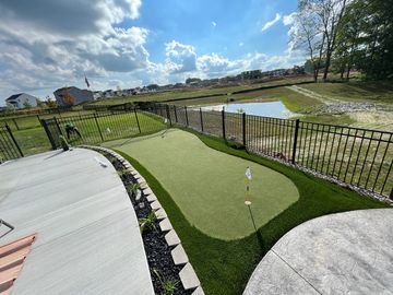 Light Green Putting Green Howell Michigan installed around backyard inground pool fake grass