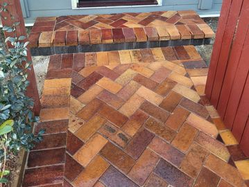 Patterned brick walkway and step.