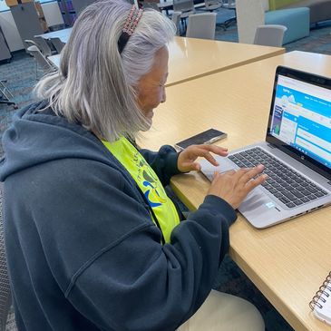 Community member practicing her typing in one of our digital learning classes.