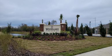 Entrance sign for Woodlake Preserve residential area with landscaping.