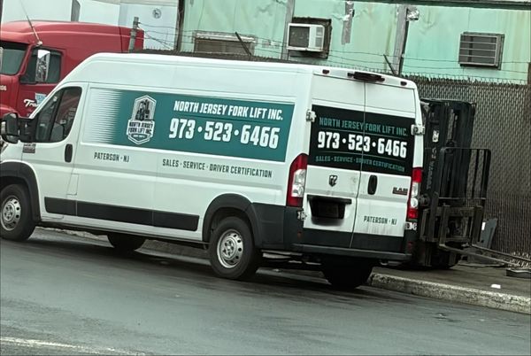 White service van for North Jersey Fork Lift Inc. parked on street.