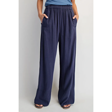 Navy blue loose-fit pants with pockets and an elastic waistband.
