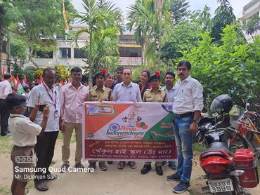 Group photo of people holding a banner for an Independence Day celebration event.