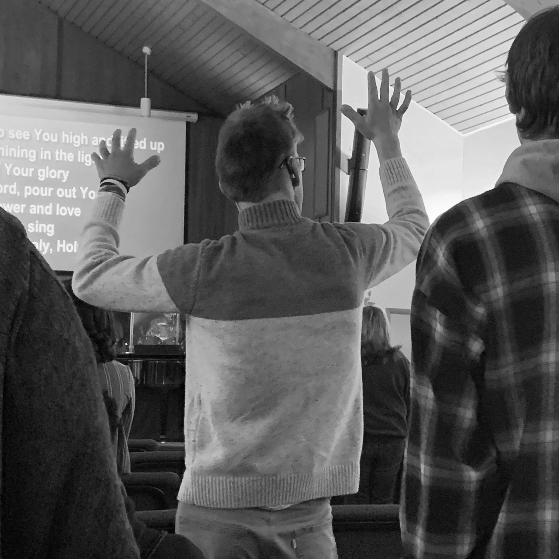 Young man, with hands lifted in worship