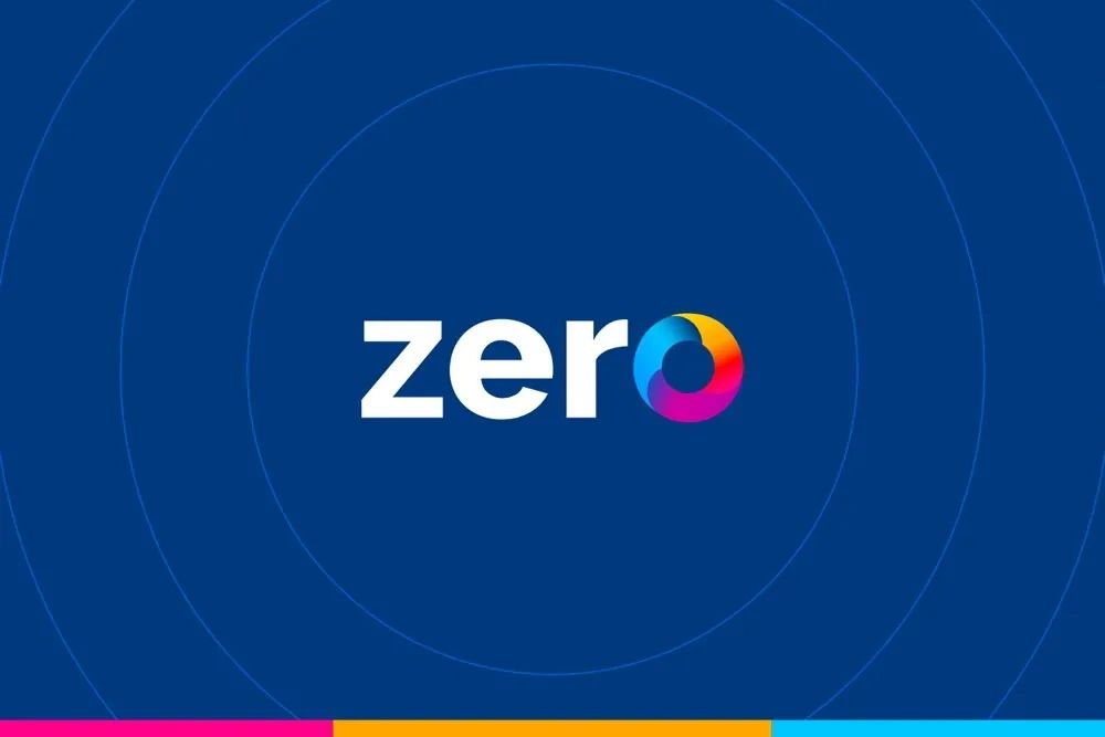 The word 'zero' with a colorful circular design replacing the letter 'o' on a blue background.