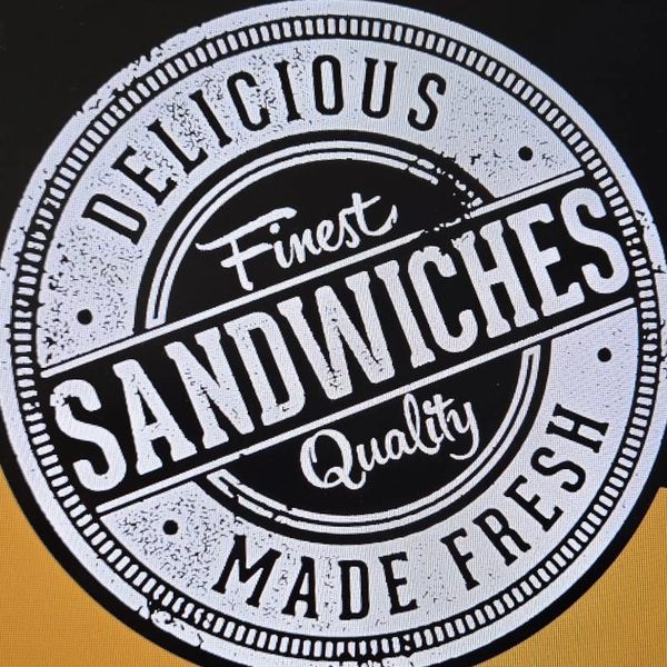 Vintage stamp design saying "Delicious Finest Sandwiches Made Fresh" on a black and mustard background.