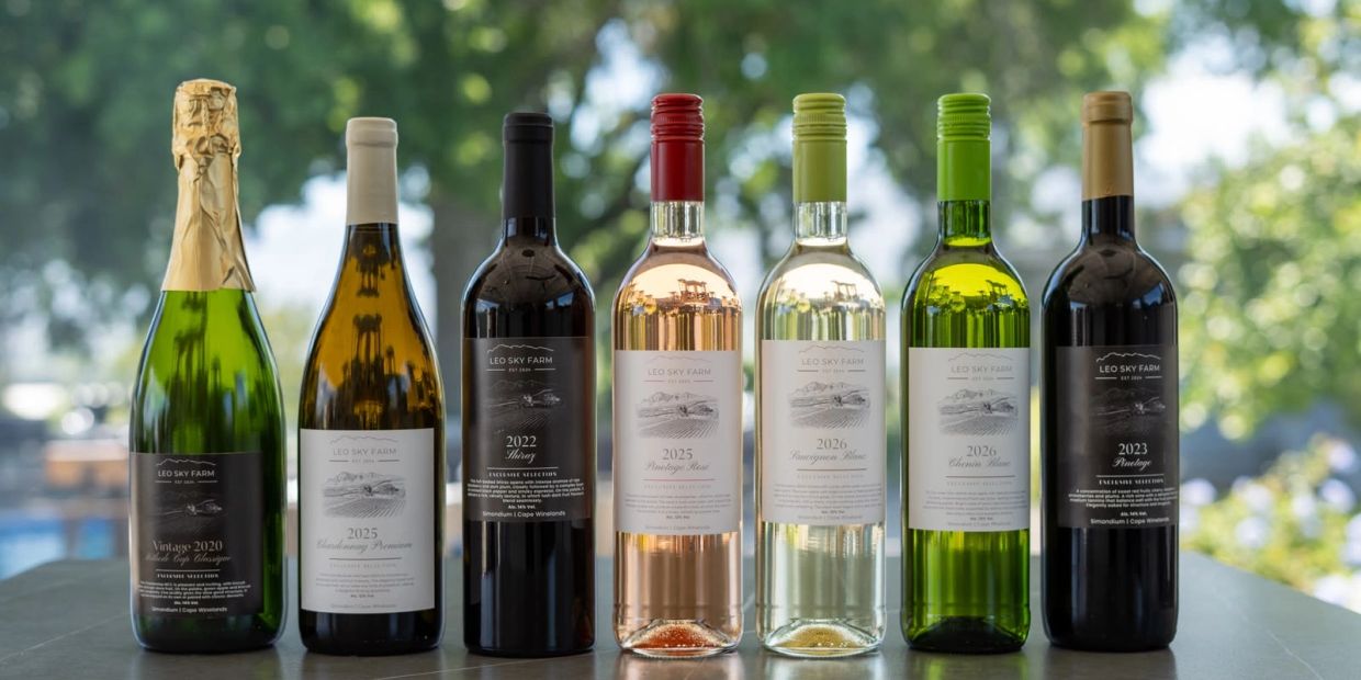 Seven bottles of wine from Leo Sky Farm arranged in a row.