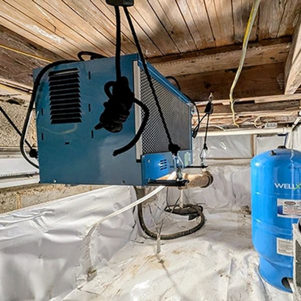 Commercial dehumidifier and well pump system in encapsulated crawlspace.