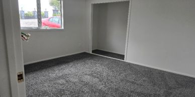 Empty room with gray carpet and white walls.