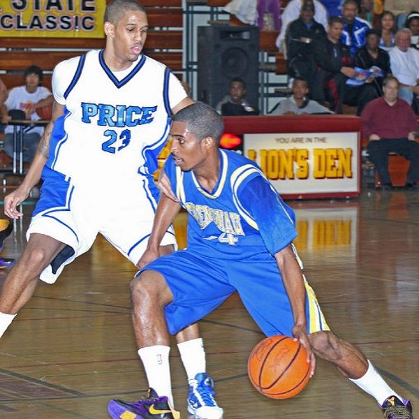 Two basketball players compete intensely during a game.