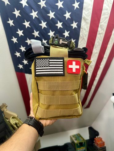 Tactical medical pouch with American flag and medical cross patches.