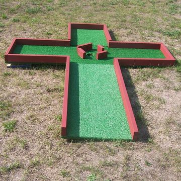 Miniature Golf Course Hole #8 is cross shaped with multiple hazards in the center around the hole.