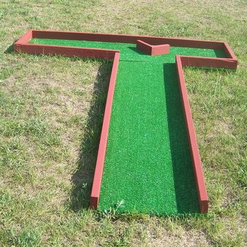 Miniature Golf Course Hole #5 is a 90° angle to the left with a V-shaped wooden hazard in the center