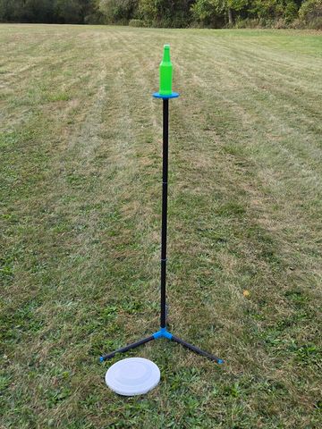 Knock The Bottle, frisbee throwing game rental is fun for all. Knock the bottle off the pole to win.