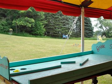 Bank Shot, roll the wiffle ball, bank it off the backboard to try and score it in one of three holes