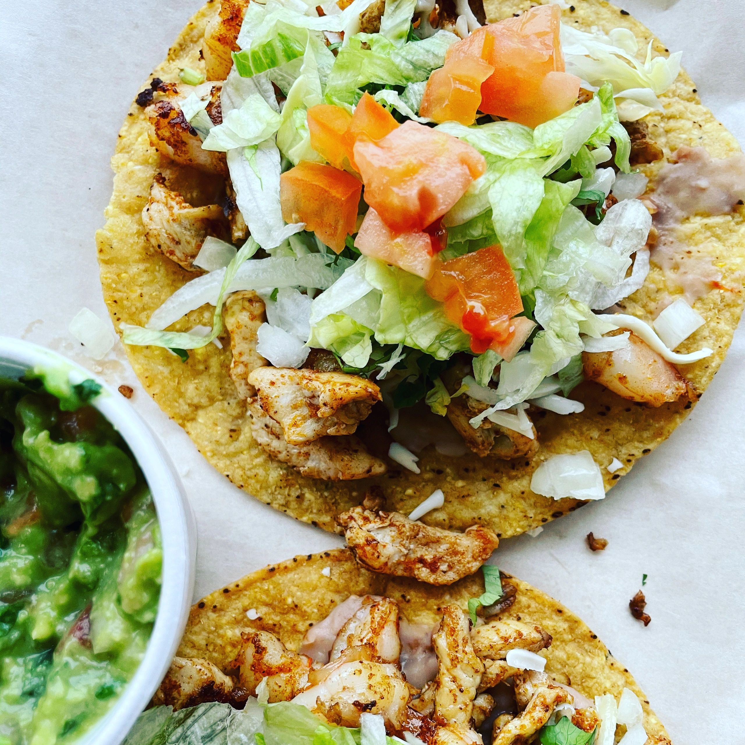 Grilled Chicken Tostadas.
Served on a flat crispy corn tortilla.
Topped with beans, choice of meat, 