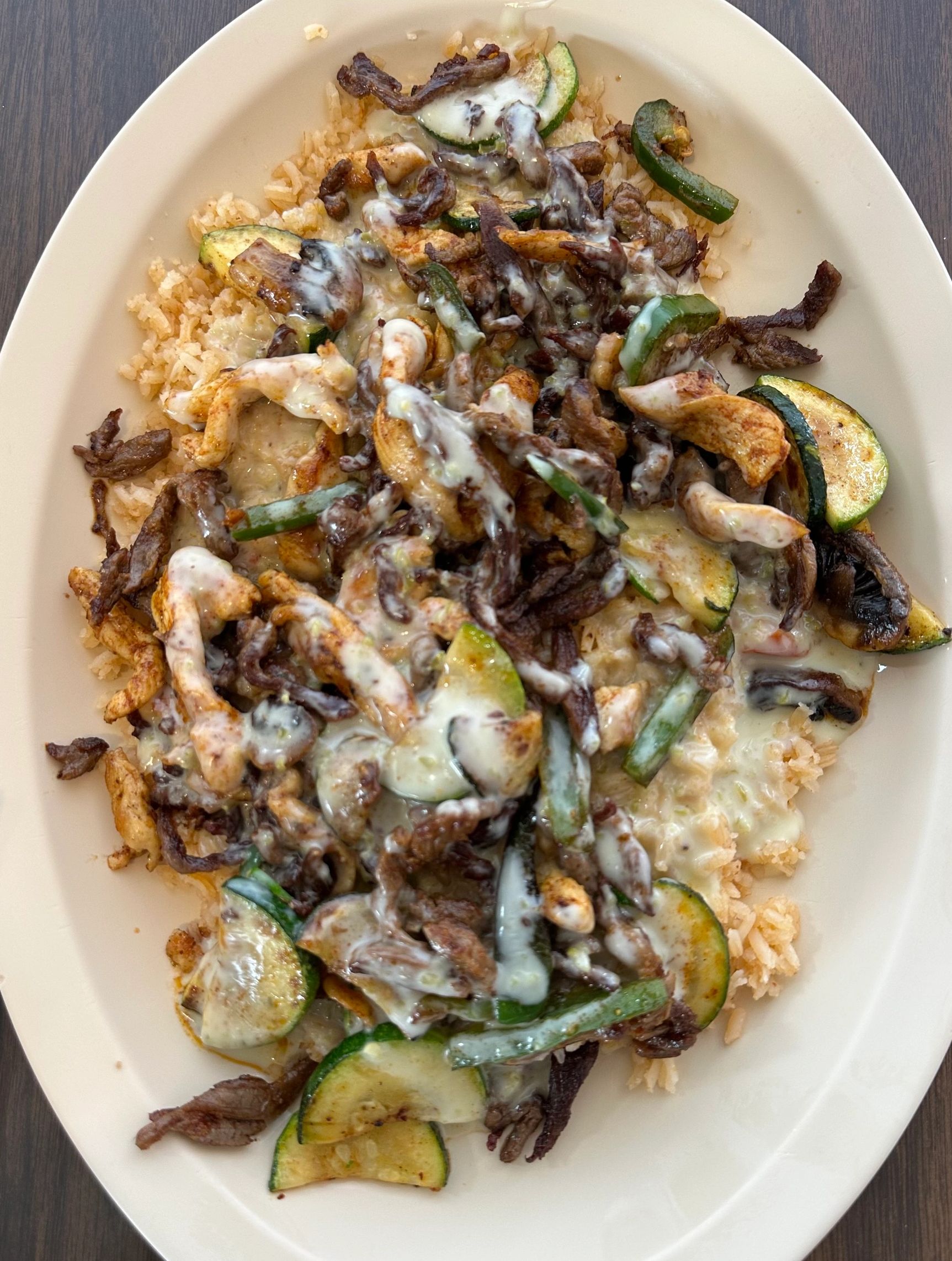Mixteco.
Grilled Chicken and Shrimp on a bed of rice topped with grilled jalapeños, zucchini squash,