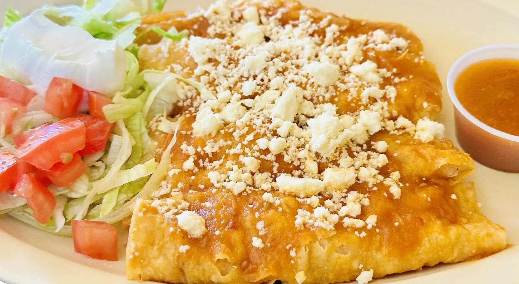 Entomatadas.
Three enchiladas with tomato sauce filled and topped with queso fresco. Served with ric