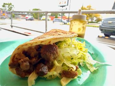 Flatbread sandwich with meat and lettuce.