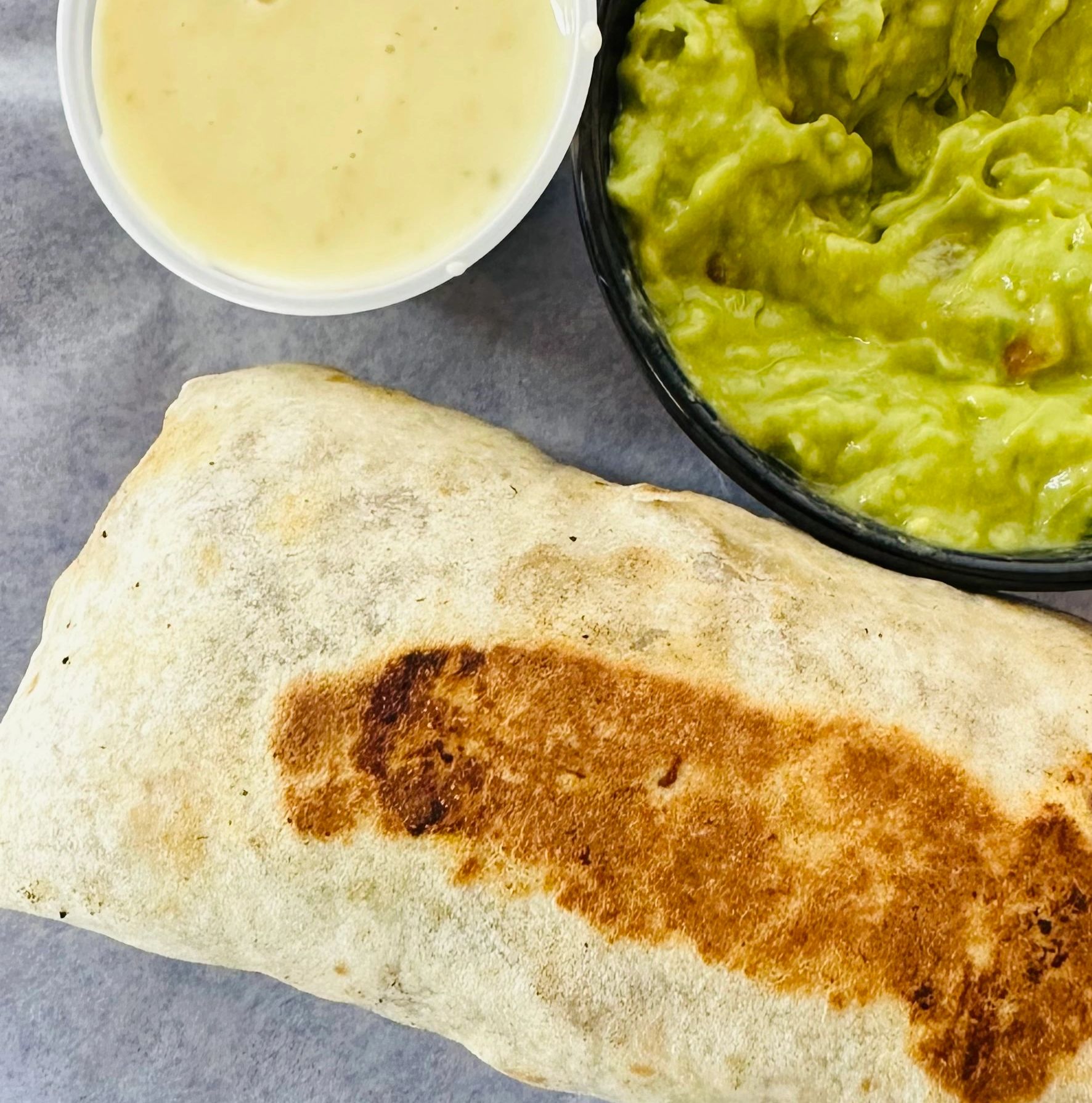 Small burrito, cheese dip, guacamole.