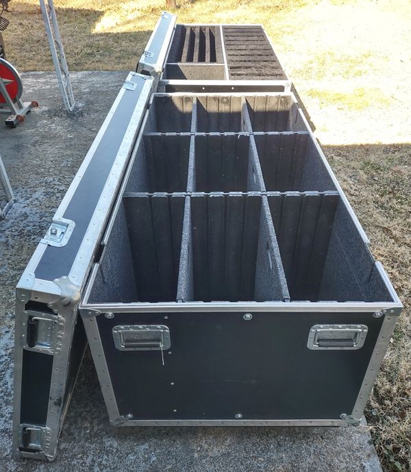 Large black equipment case with multiple padded compartments and an open lid.