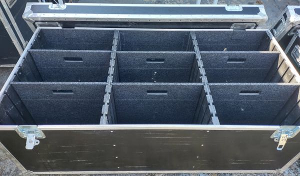Large black storage case with multiple padded compartments for equipment.