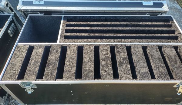 Empty foam-lined case with multiple compartments for organizing equipment.