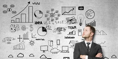 Businessman analyzing growth charts and ideas on a wall.