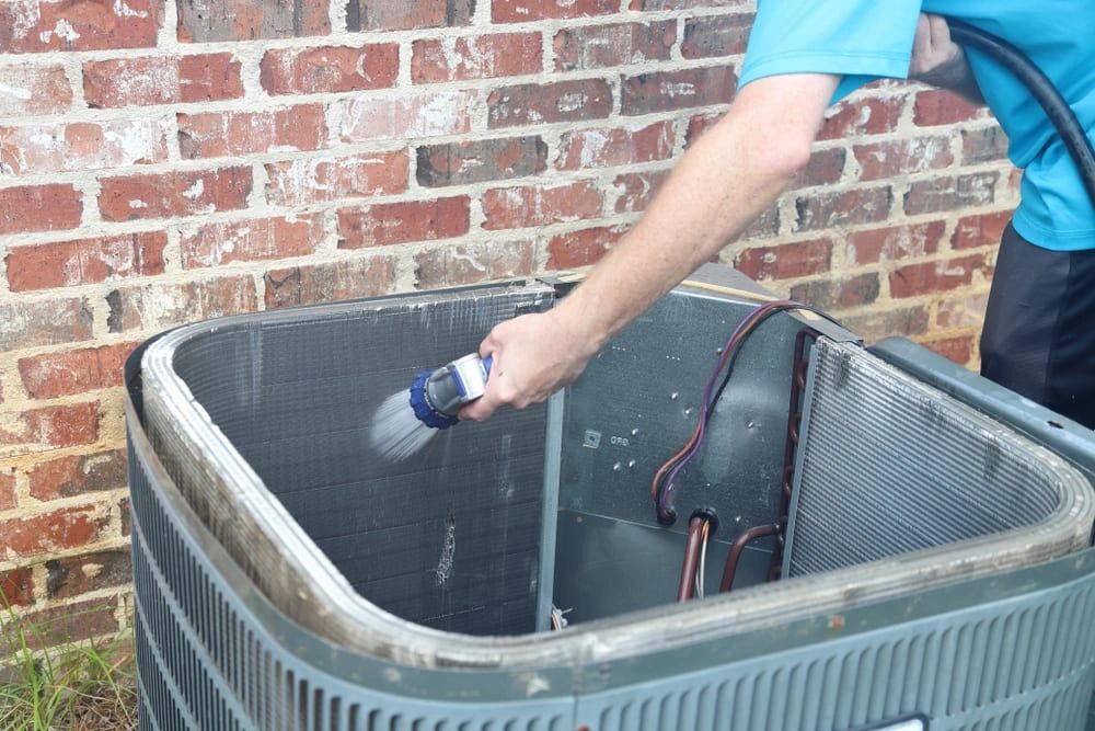 Remove soil from condenser fins with garden hose spray.