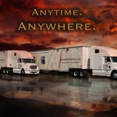 Two large white trucks with a cloudy sunset sky background.