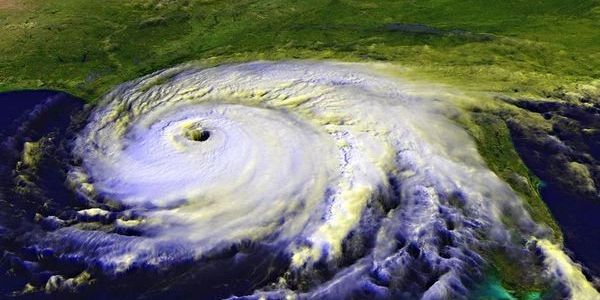 Satellite image of a hurricane approaching land with a visible eye.