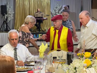 Elderly people socializing with live music in the background.