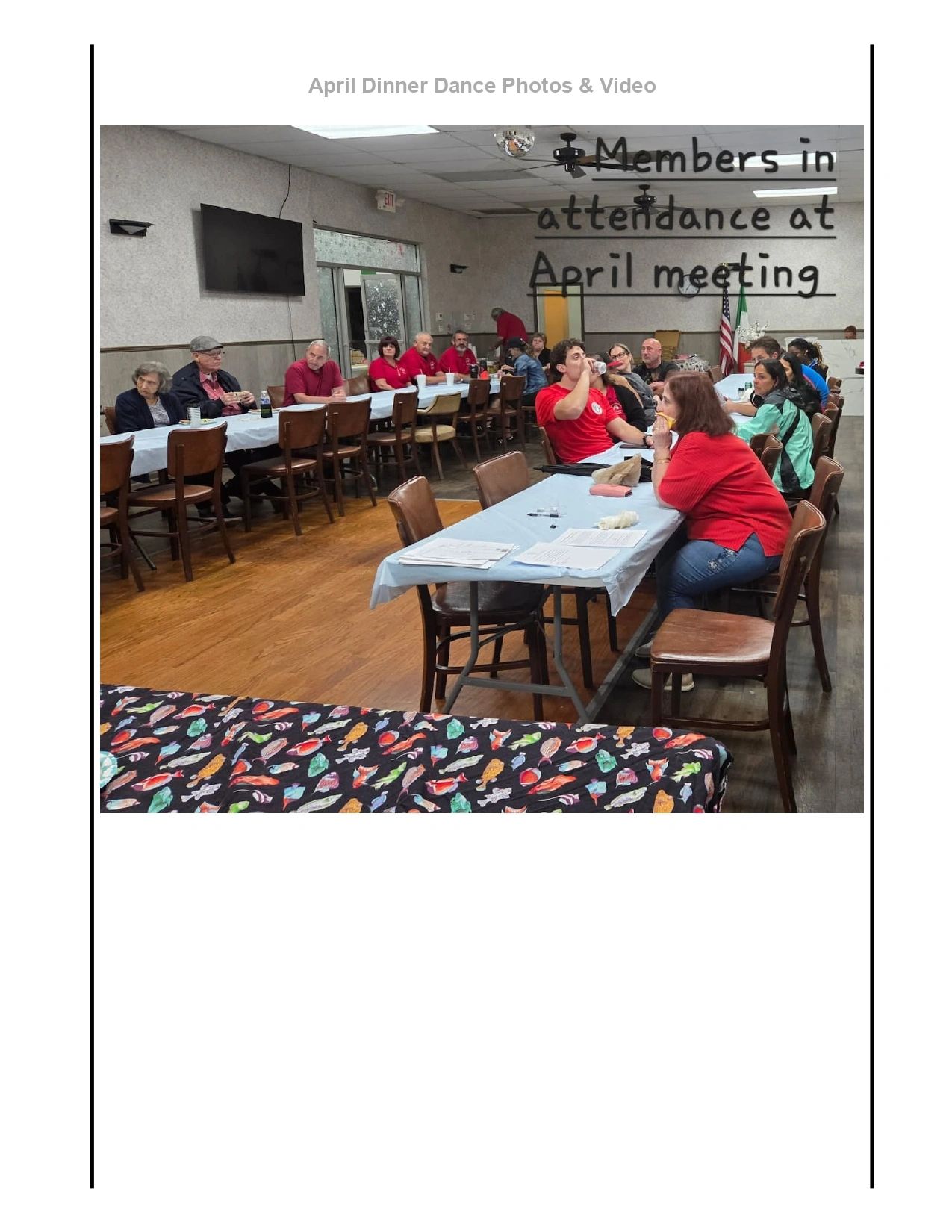 Group of members attending an April meeting in a community hall.
