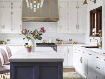 Custom cabinetry and inset frame in a transitional shaker door Gold hardware blue and white cabinets