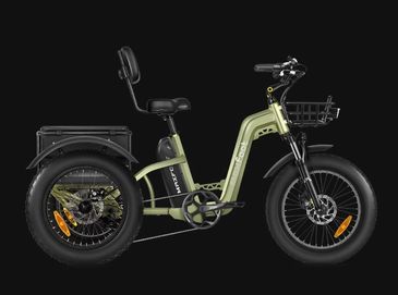 Green electric tricycle with basket and padded seat against black background.