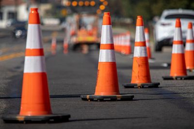 Orange traffic cones lined up on a road for safety.