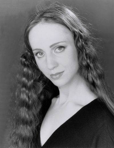 Black and white portrait of a woman with long wavy hair.