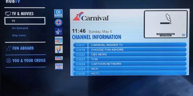 TV menu screen on a Carnival cruise ship showing channel options and smoking policy.