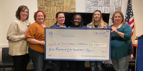 Group holding a large ceremonial check for $9,500.