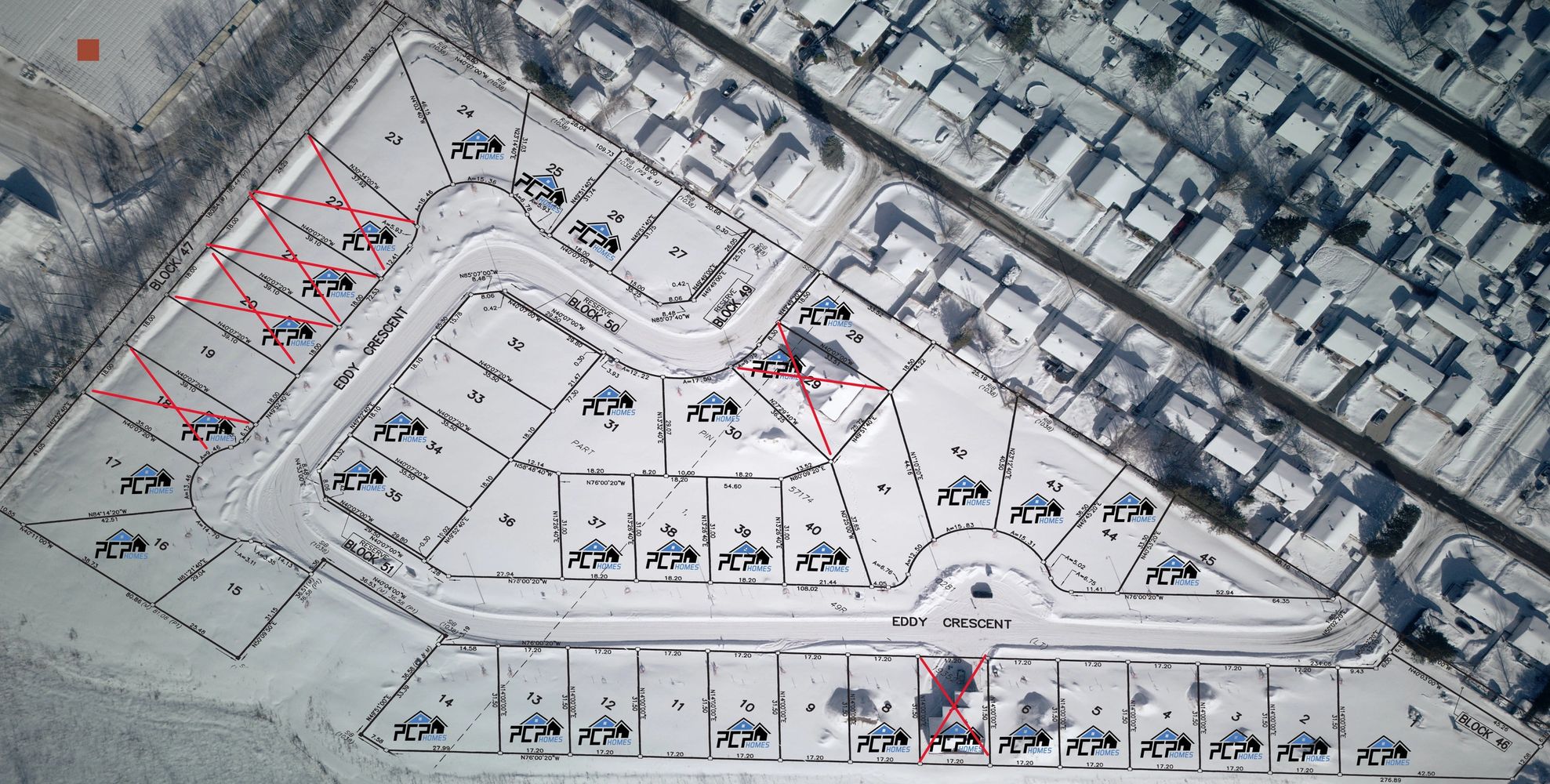 Snow-covered residential plots and houses mapped with some lots marked and crossed out.