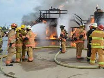 Firefighters battling a large blaze at an industrial site.