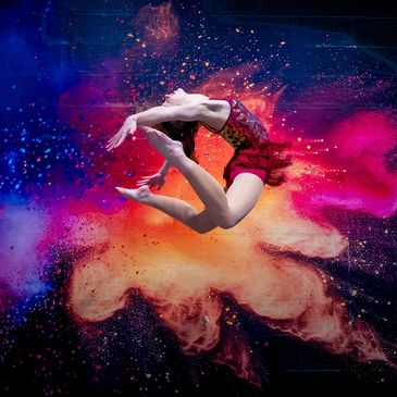 Dancer performing a backflip with colorful powder explosion.