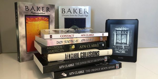 All Clarke's books in a stacked pile showing spine, titles, covers with Kindle reader on the right