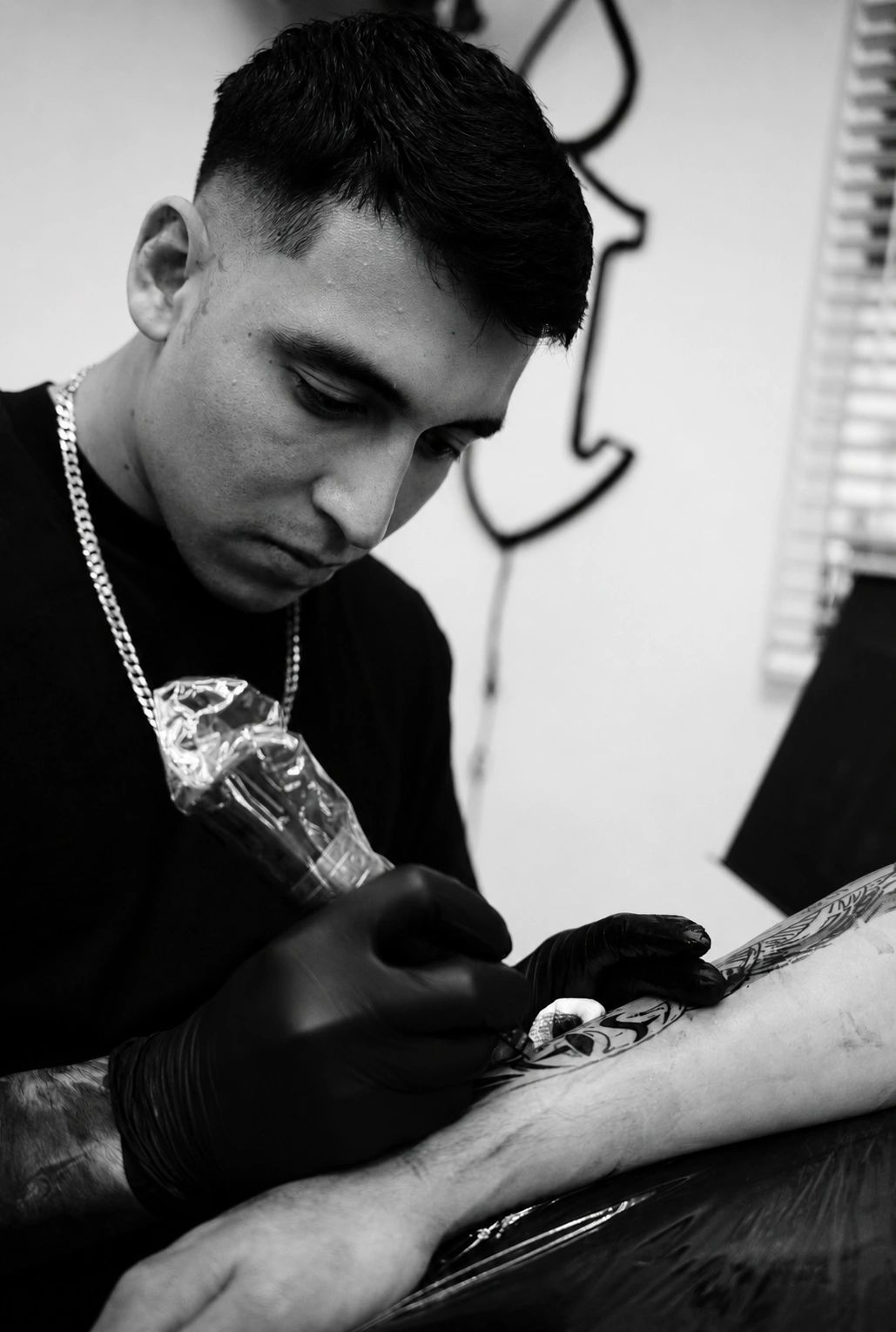 Tattoo artist focused on his work.