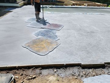 Stamped concrete in seamless stone texture. The deck will be cut and washed the next day.