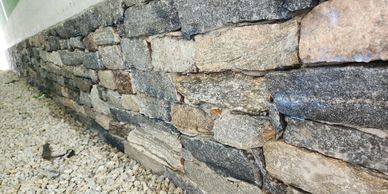Stone veneer masonry repair restoring appearance and structural integrity.