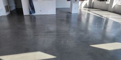 Polished concrete floor with smooth, low-maintenance finish in an art gallery interior space.