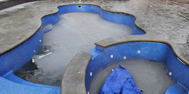Concrete pool deck with cantilever coping and textured, slip-resistant finish.