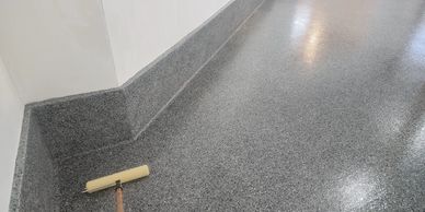 Epoxy garage floor with treated walls. In a flake,  seamless durable finish.