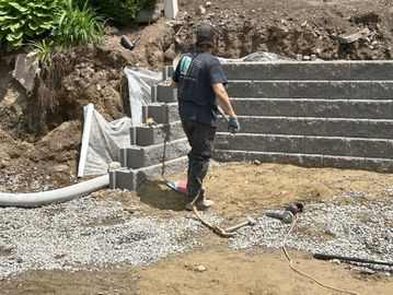 Allan Block wall in progress. Drainage and crushed stone. A retaining wall installer.